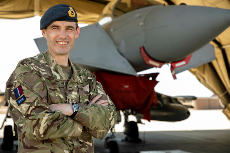 Air Commodore Mark Farrell stand cross armed in-front of an aircraft..